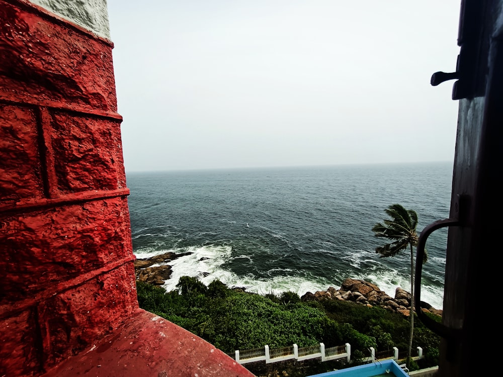 a red building overlooking a body of water