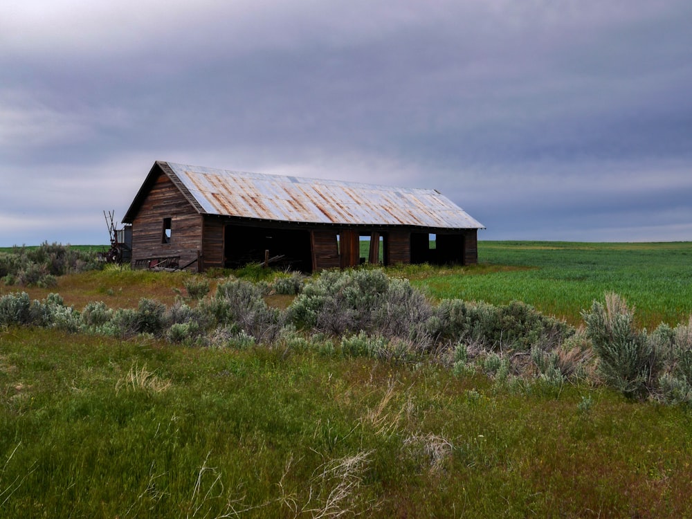 a wooden house in a field