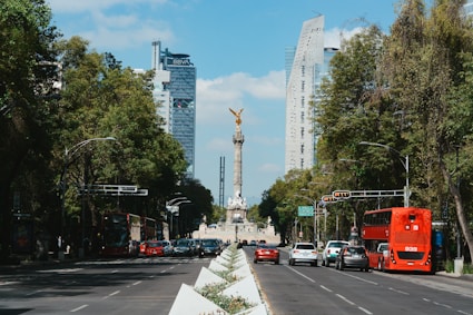 a city street with a monument in the background