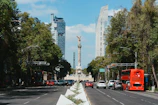 a city street with a monument in the background