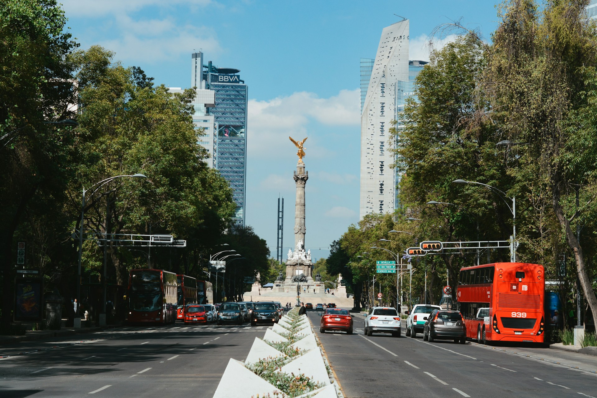 a city street with a monument in the background