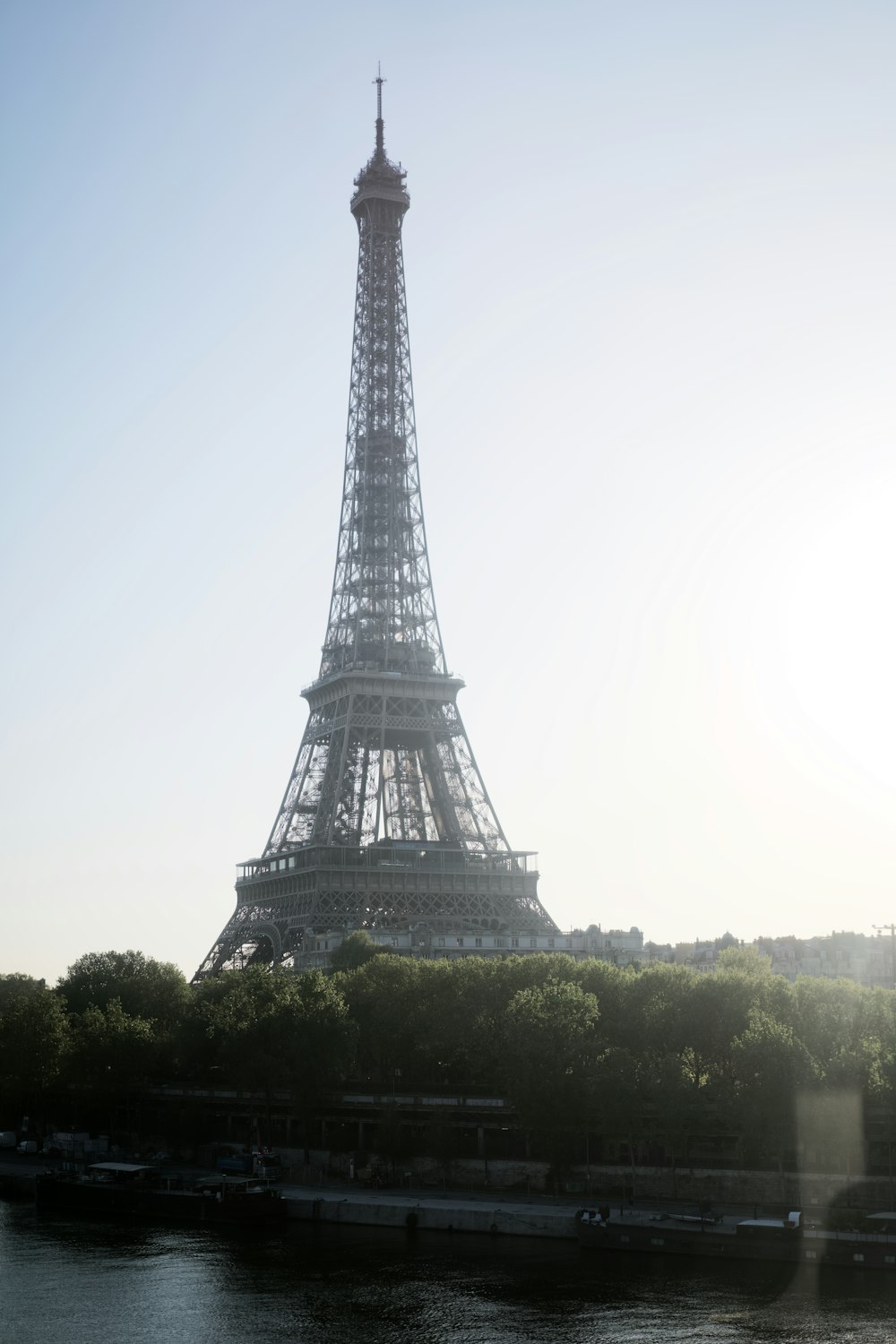 a tall metal tower with Eiffel Tower in the background