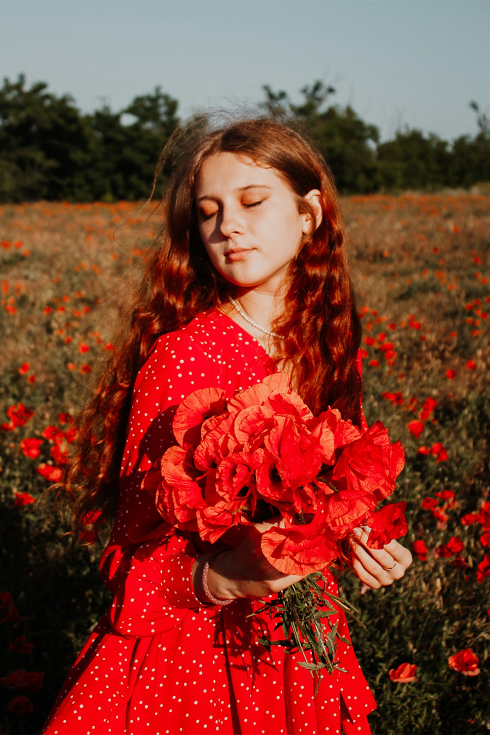 a person in a red dress in a field of flowers