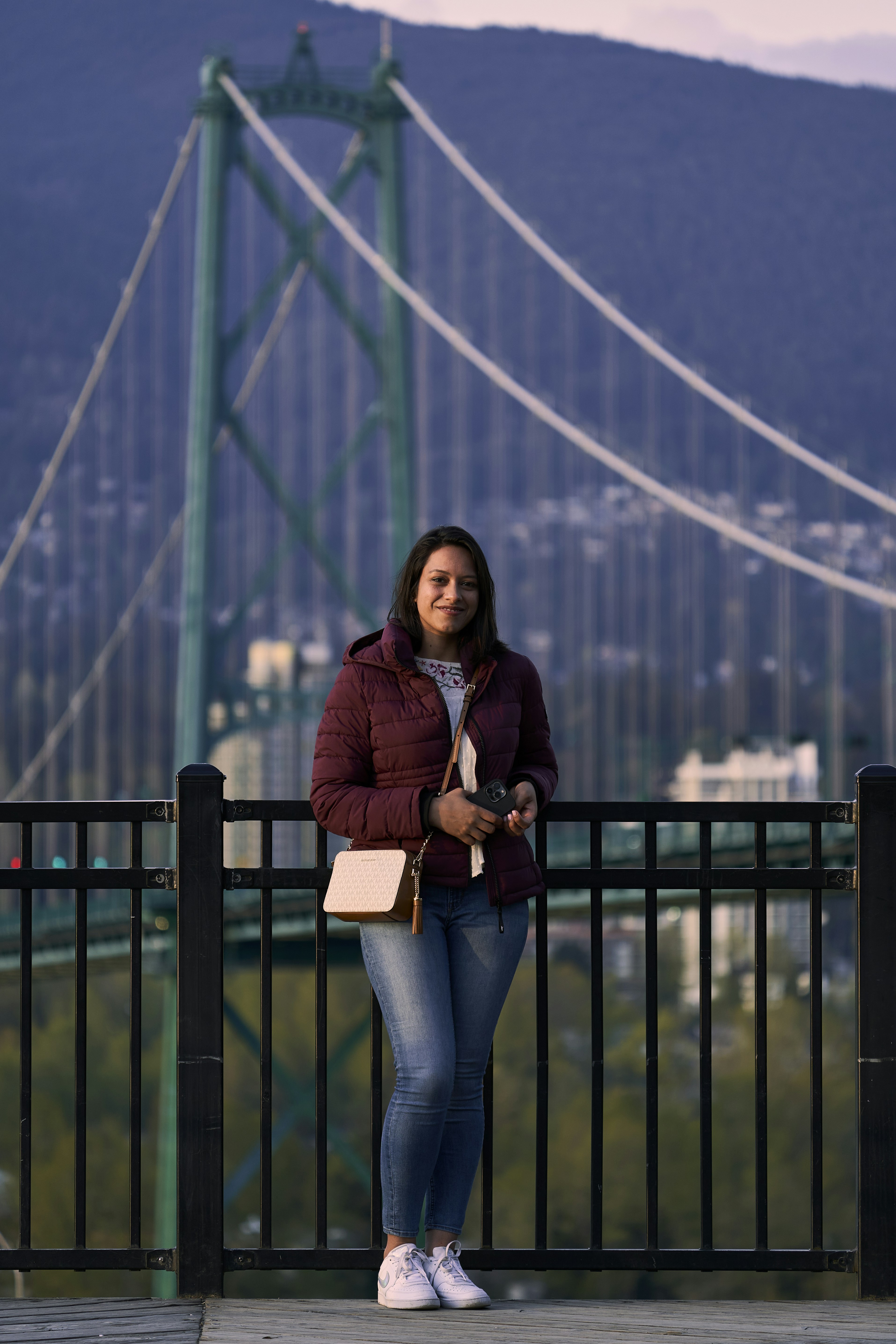 a woman standing on a bridge