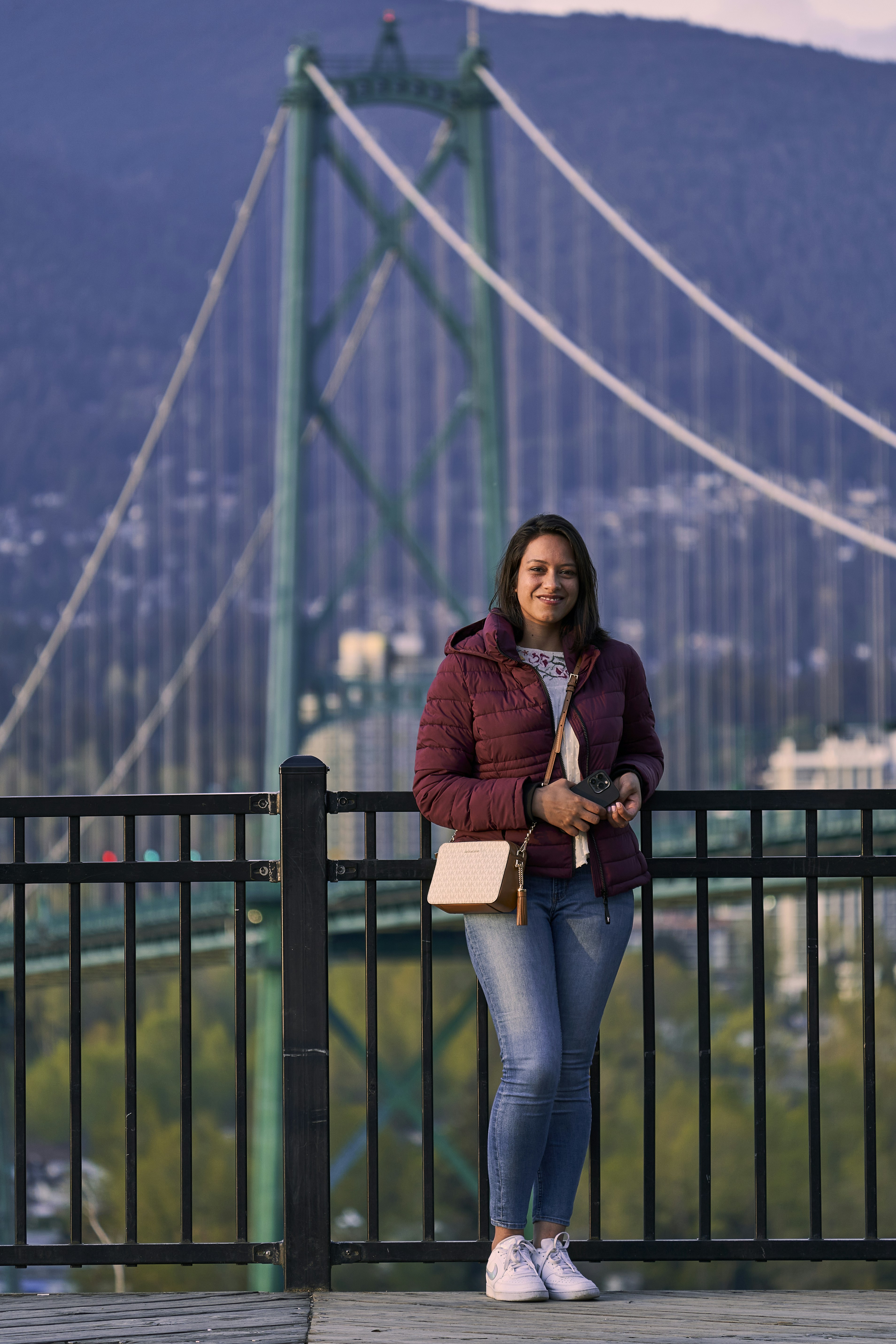 a woman standing on a bridge