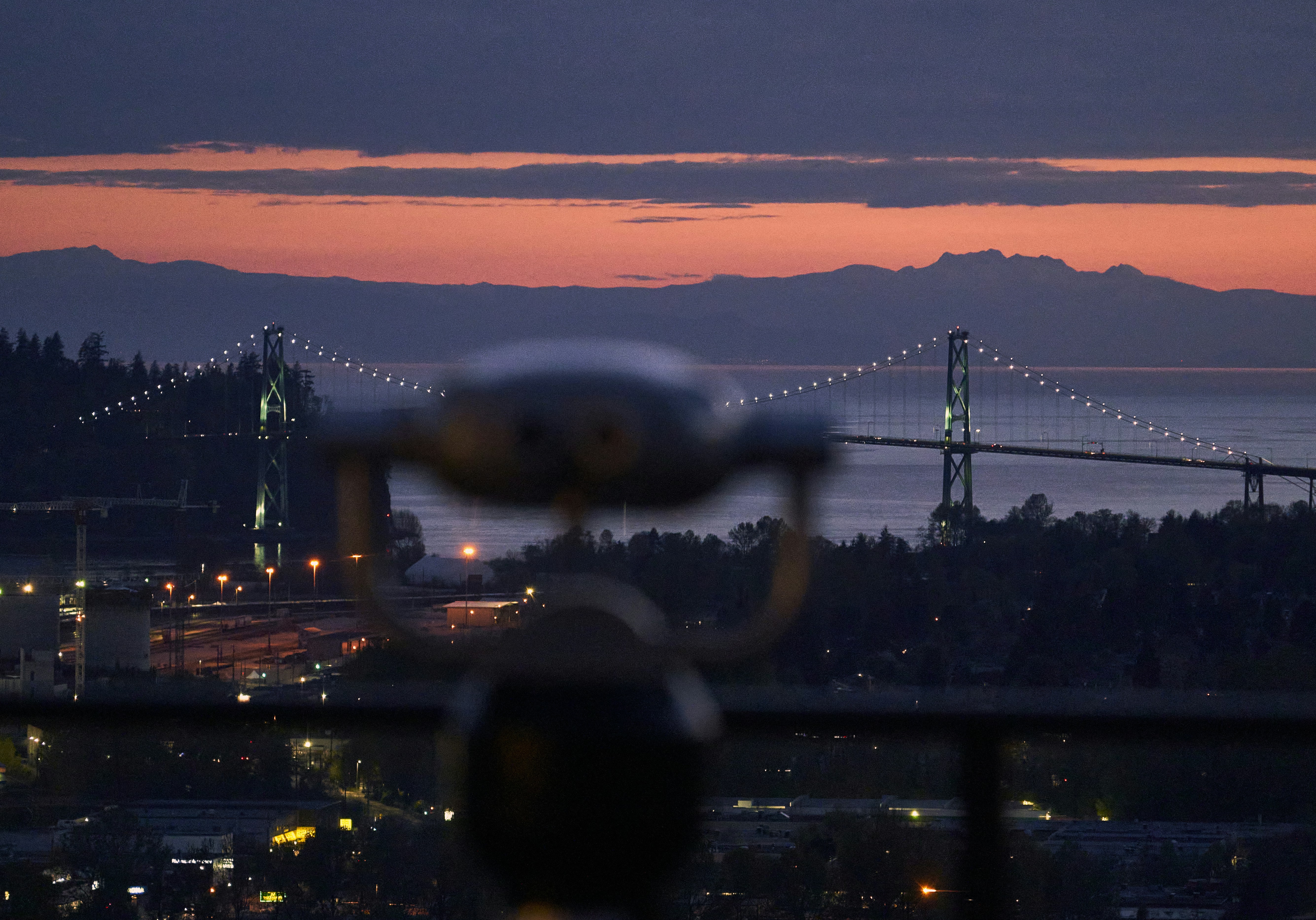 a large propeller plane flying over a city at night