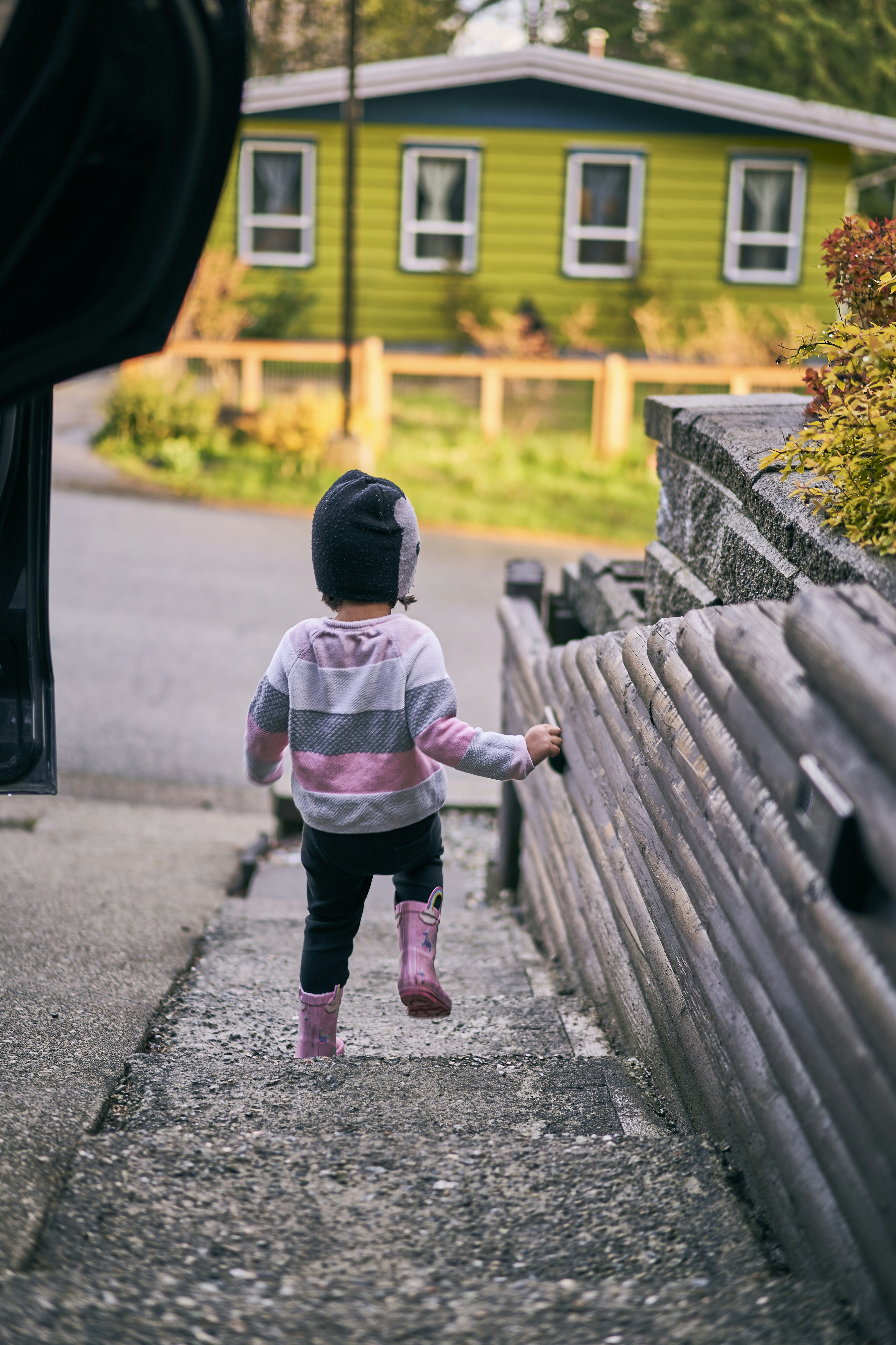 a child walking on a sidewalk