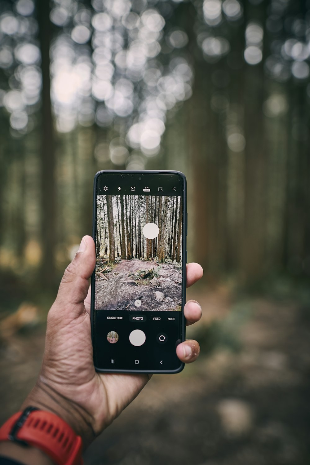 a hand holding a black device