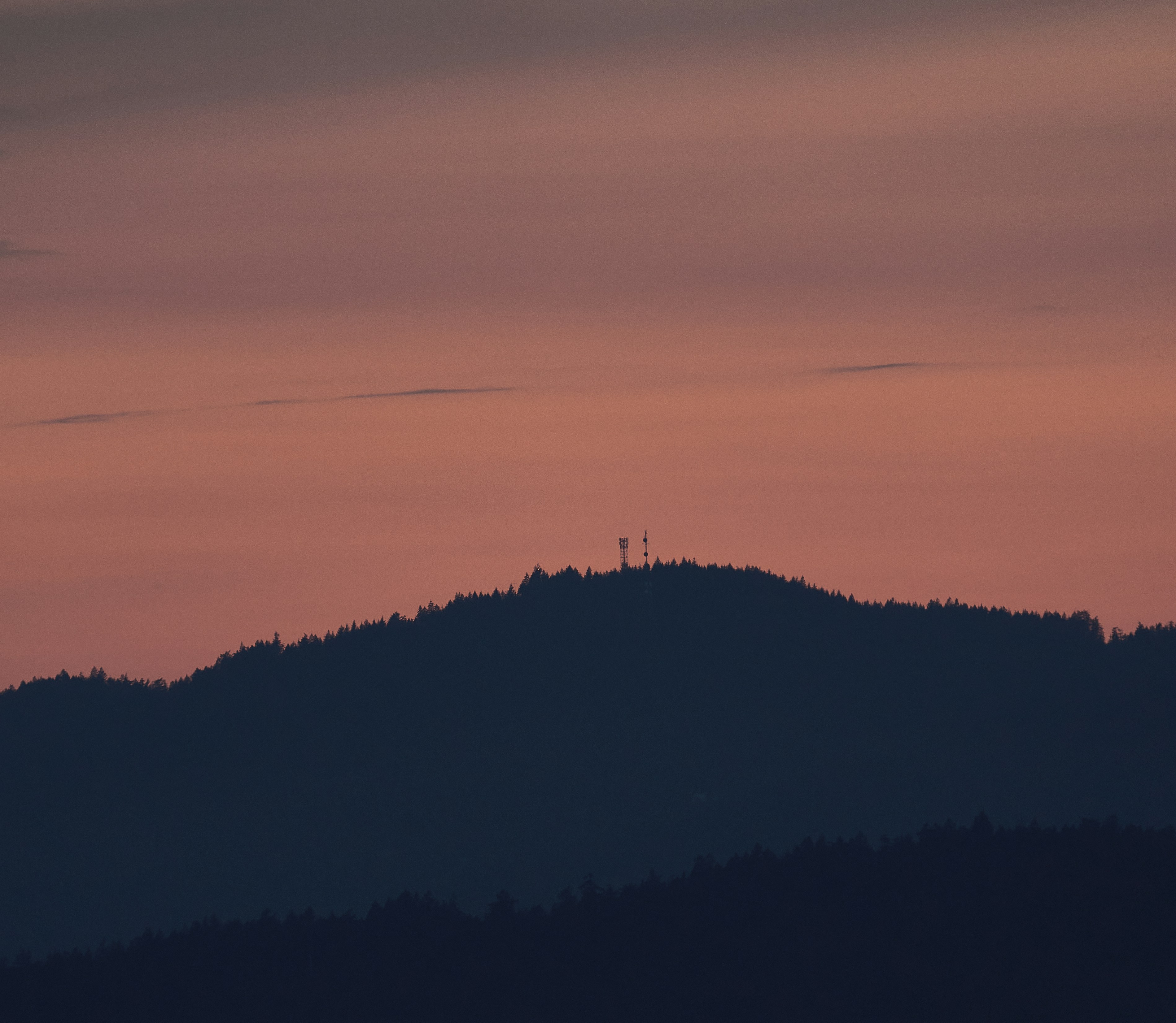 a hill with a sunset in the background