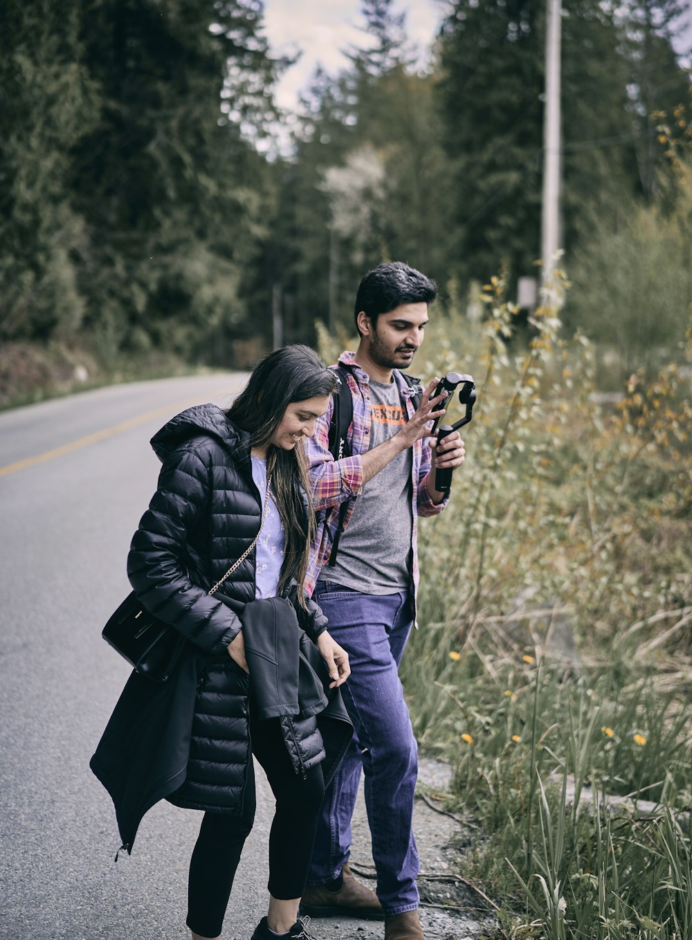 a man and woman taking a picture together on a road