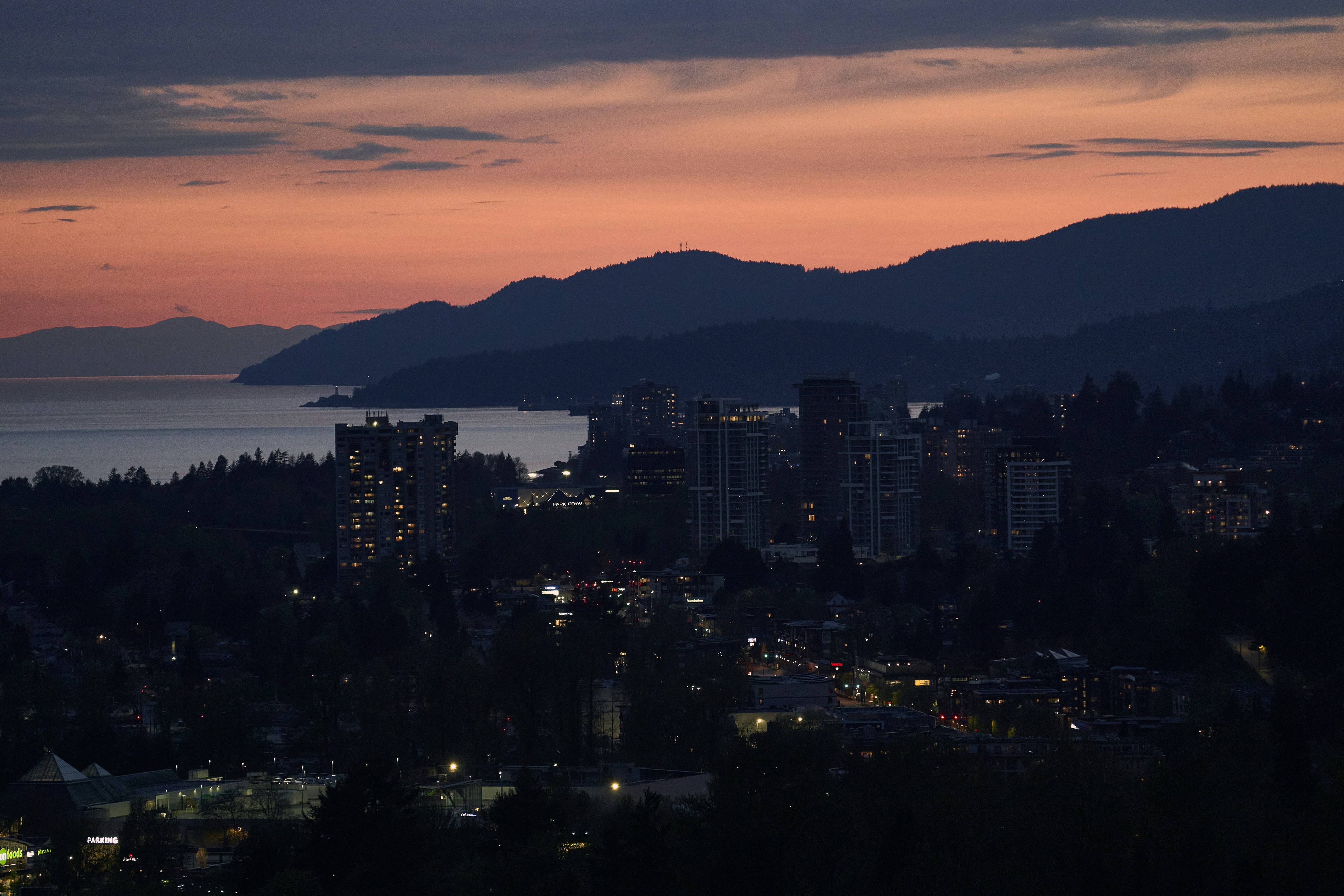 a city with a body of water in the background