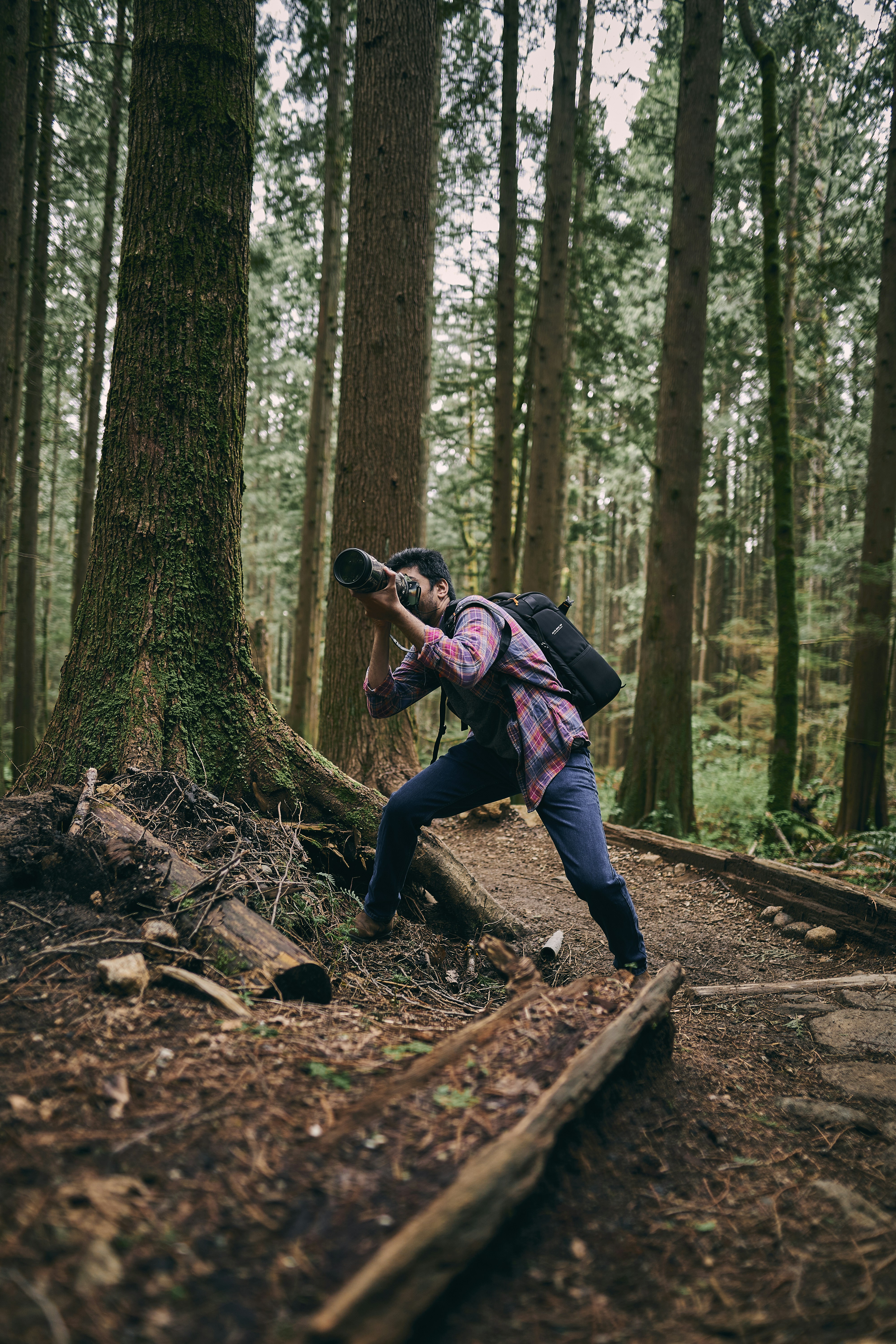 a person taking a picture in the woods