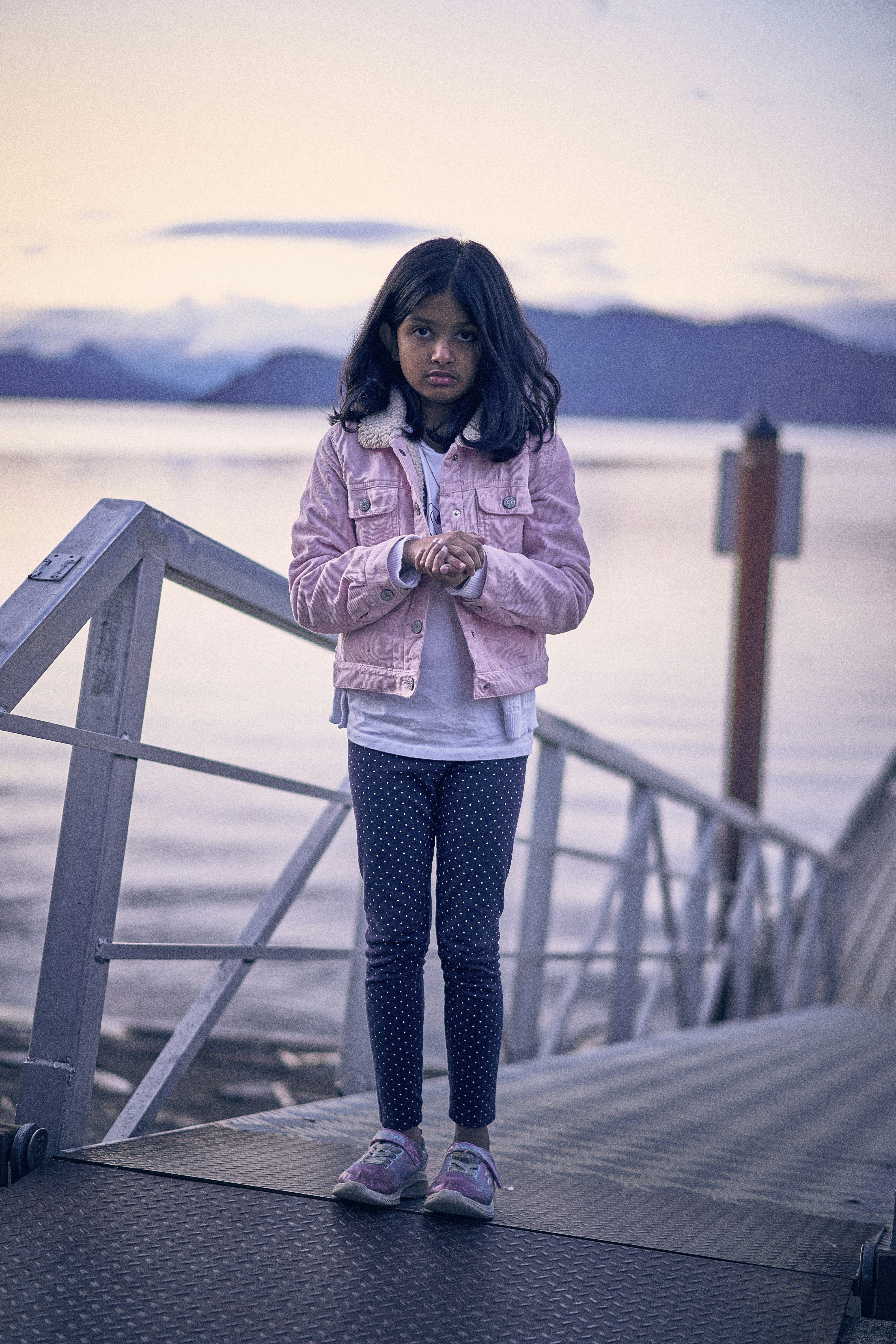 a woman standing on a bridge