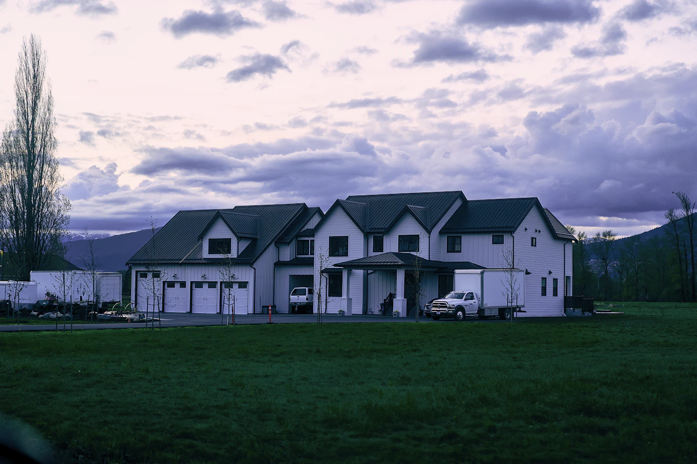 Two-story house with a three-car garage at dusk