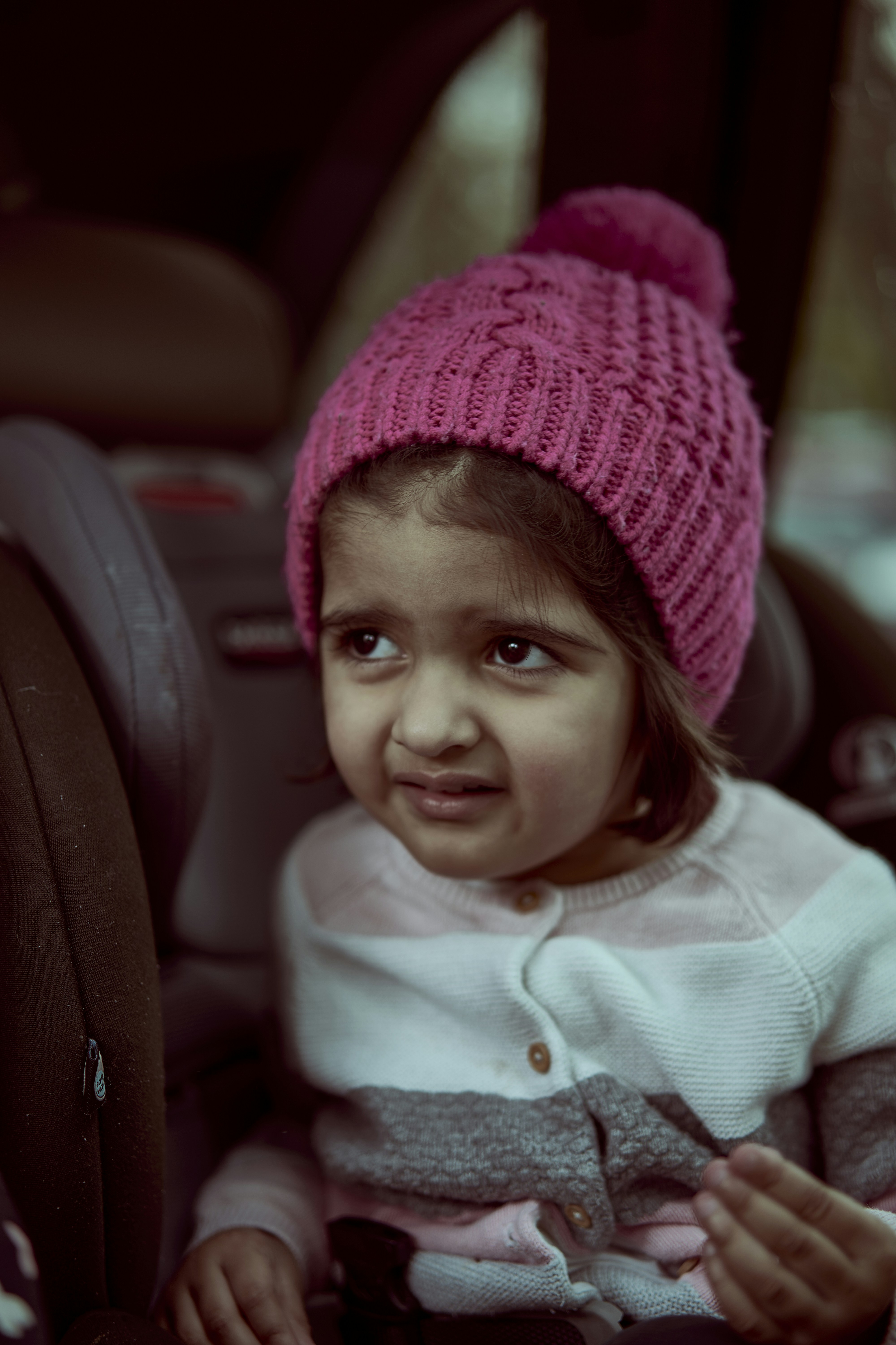 a baby wearing a pink hat