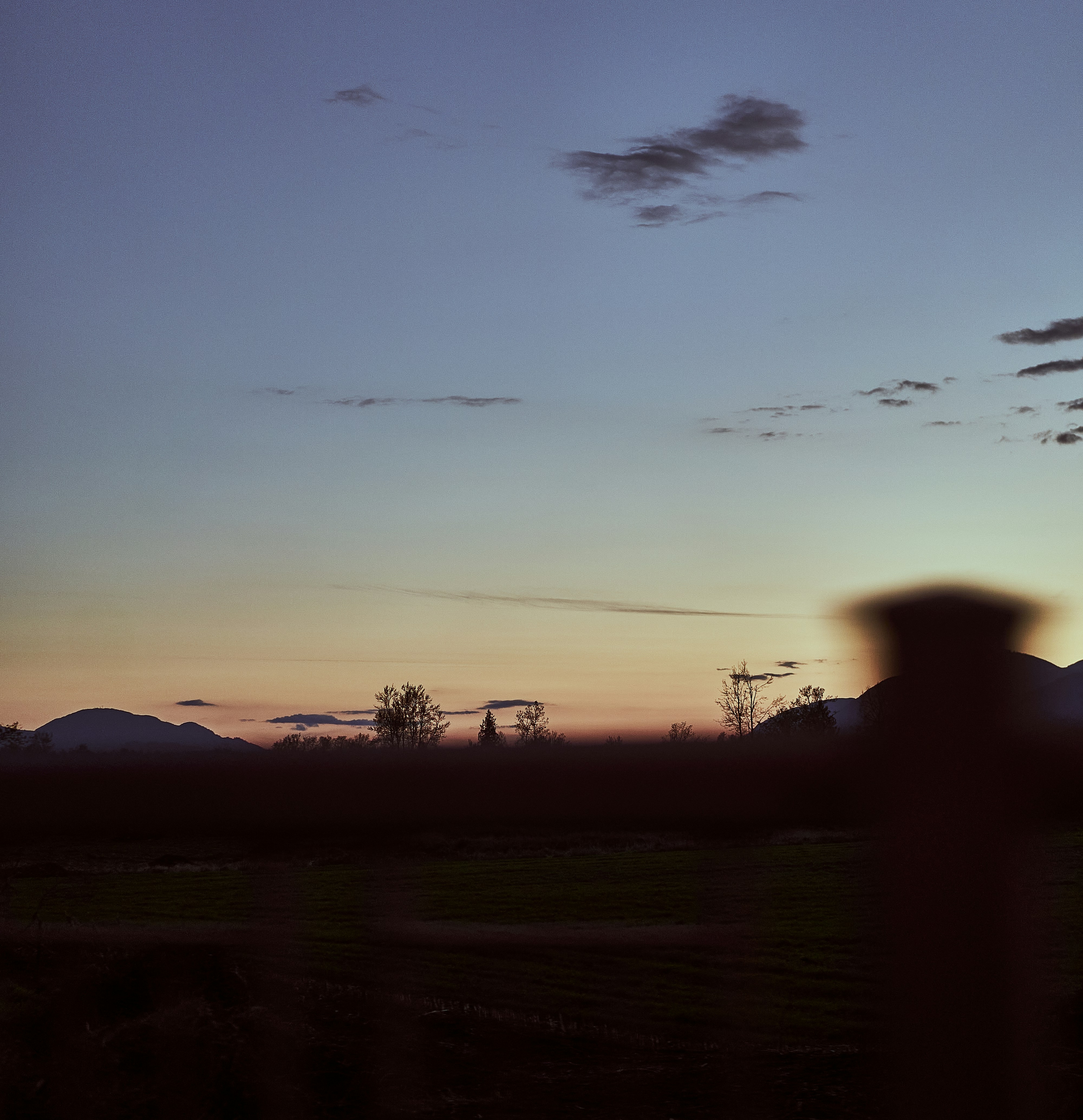 a person standing in front of a sunset