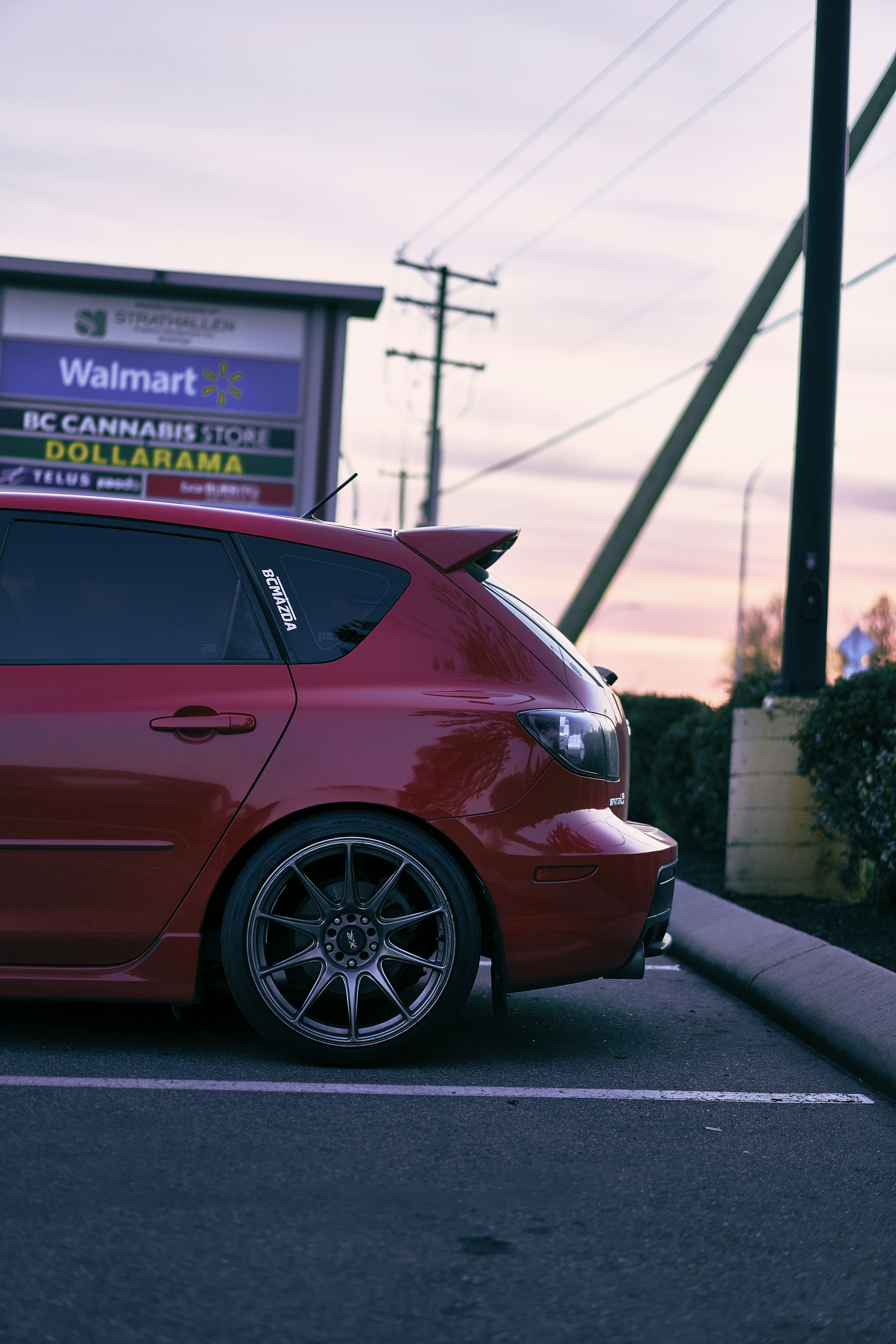 a red car parked on the side of a road