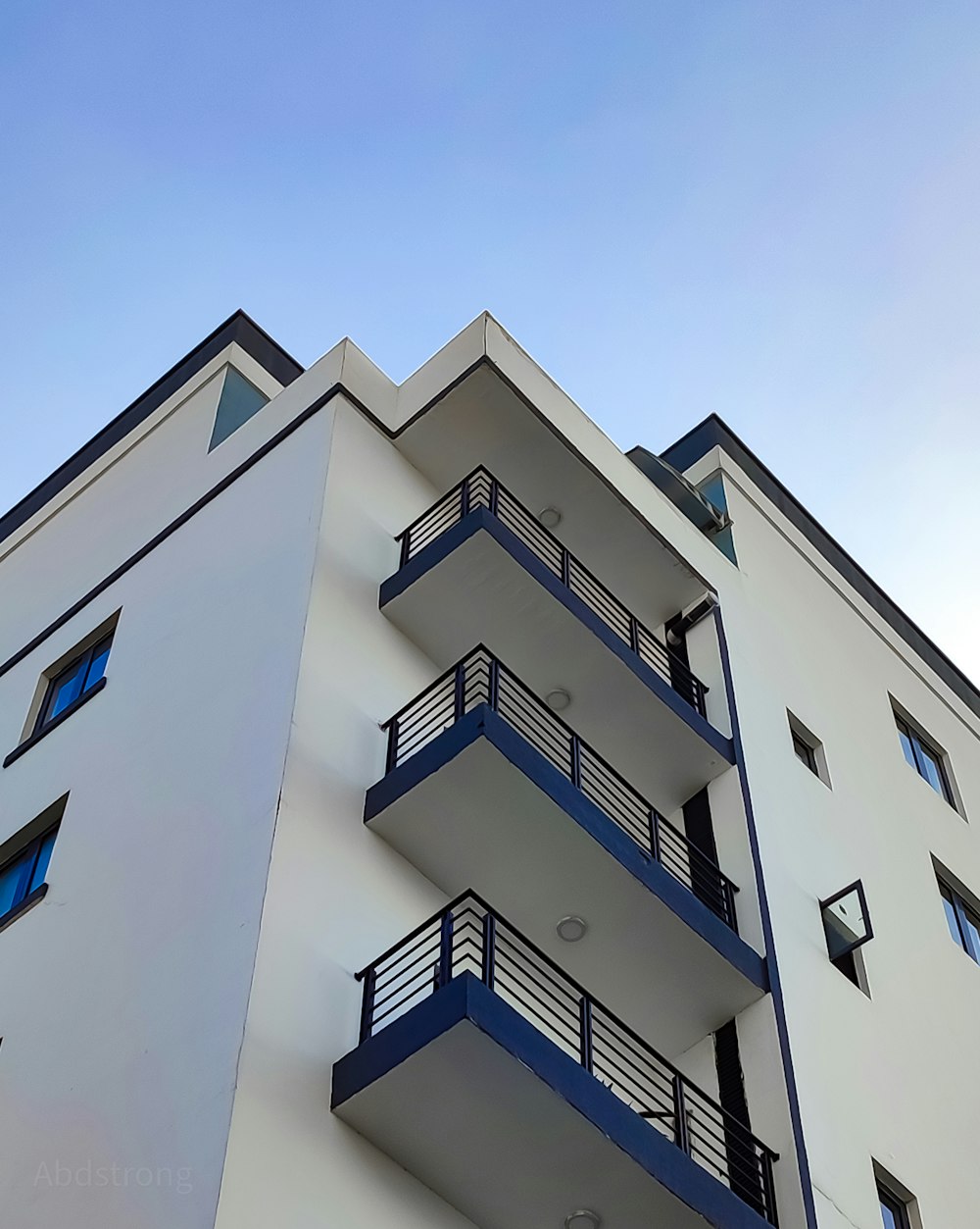 a building with balconies and a blue sky