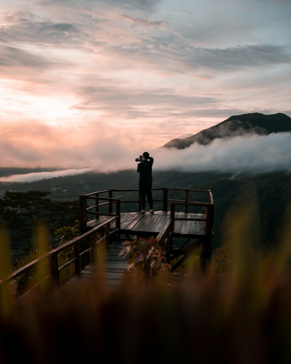 a person standing on a bridge