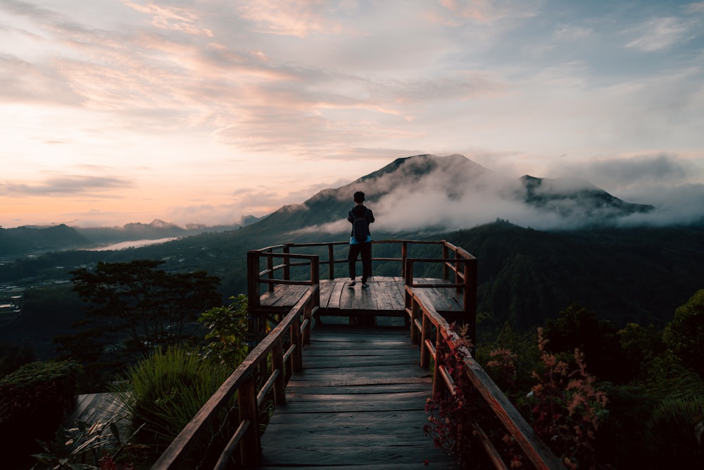 a person standing in front of a mountain