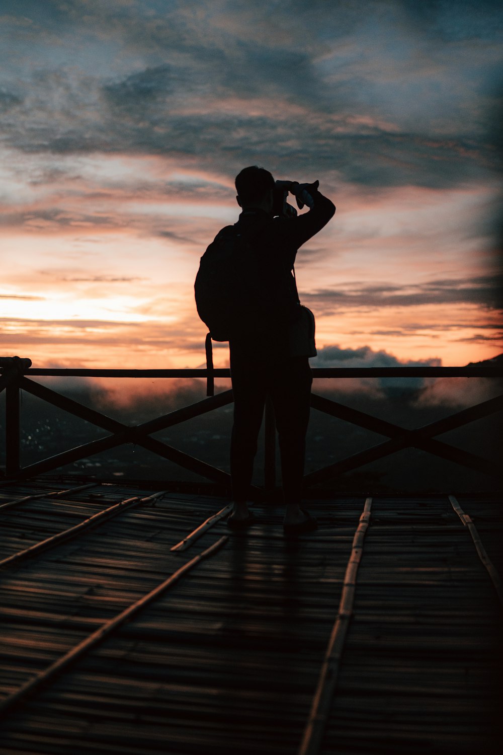 a person standing in front of a sunset