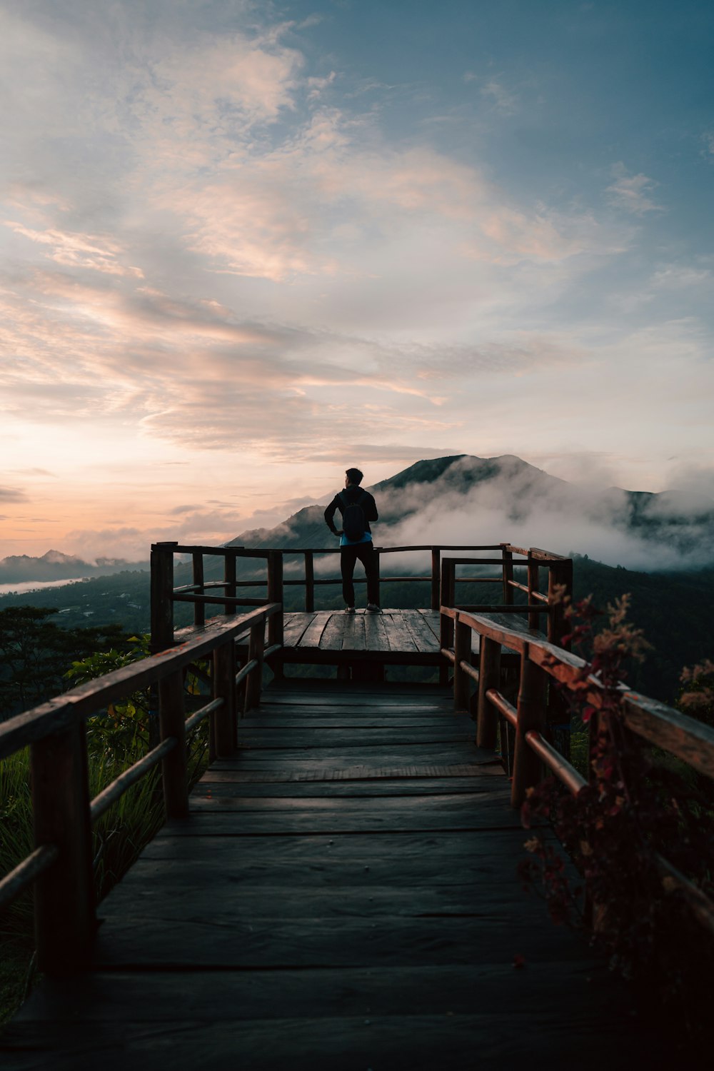 a wooden pier next to a body of water