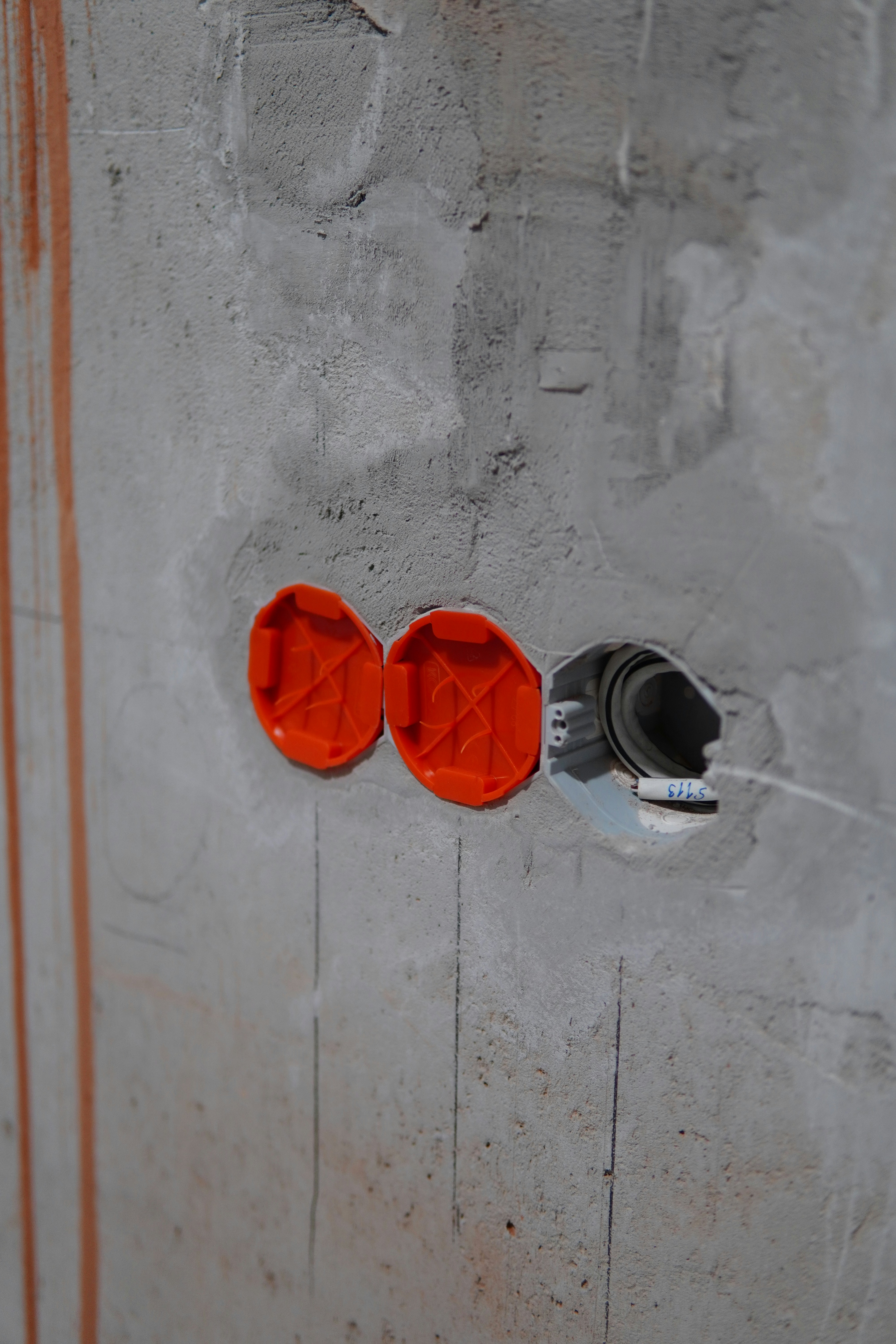 a pair of red and white earbuds on a white surface