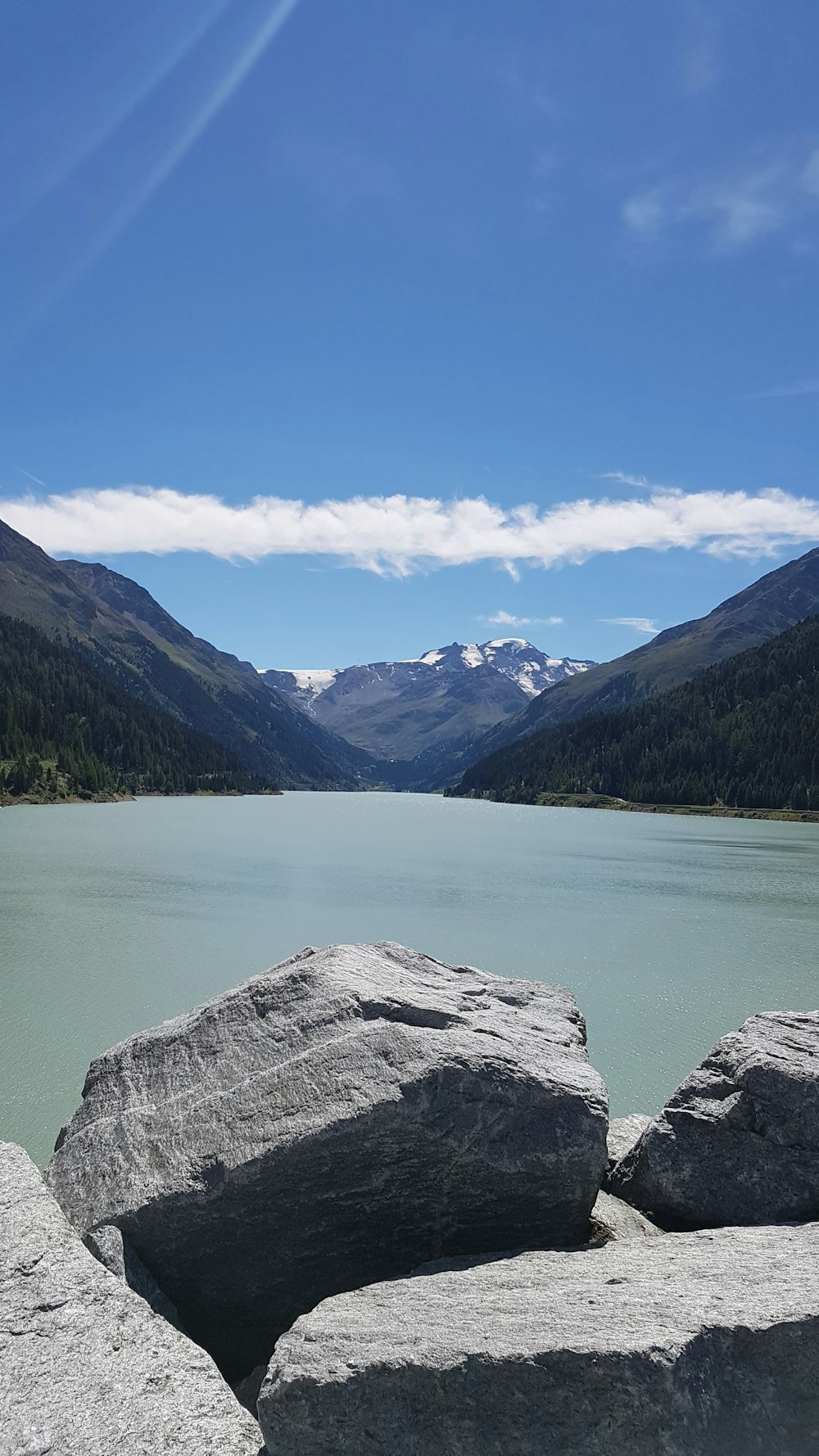 a body of water with mountains in the background