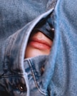 a person's face in a pair of jeans