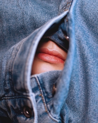 a person's face in a pair of jeans
