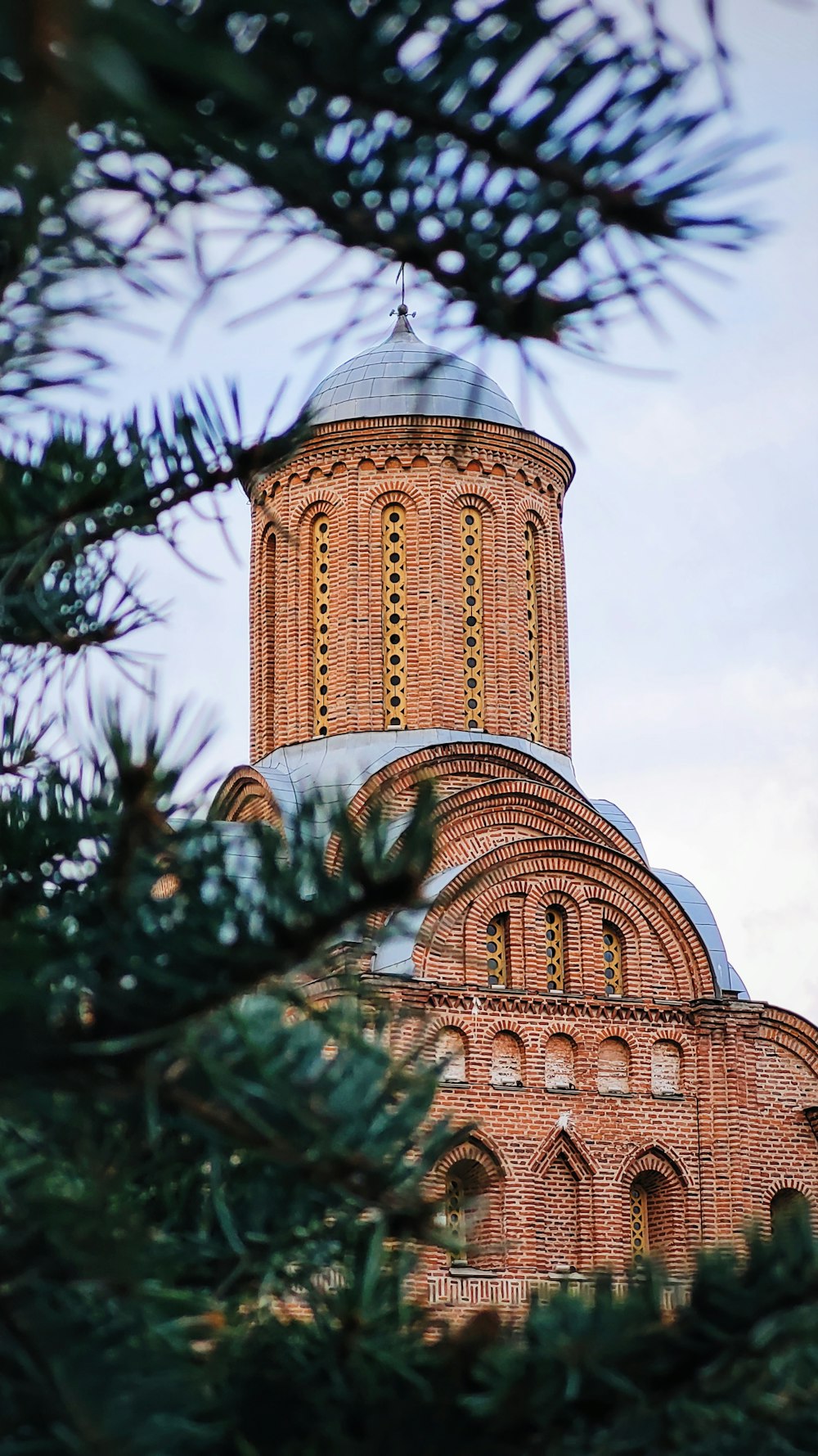 a building with a dome and trees in front of it