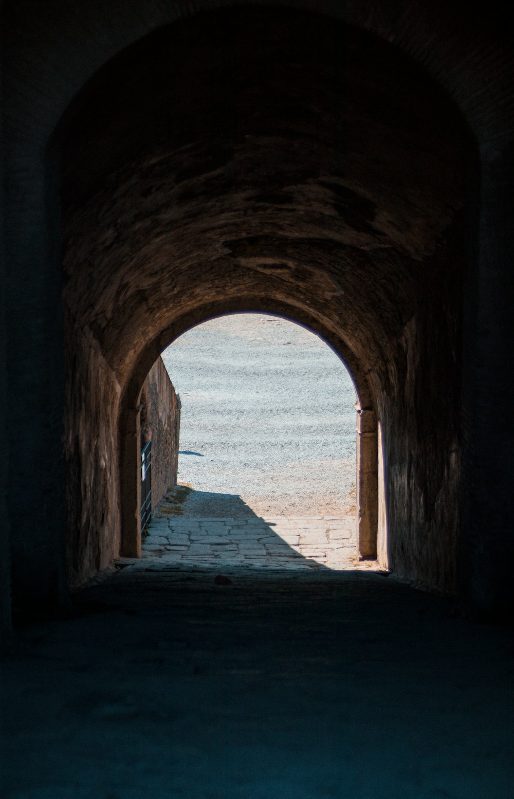 a stone tunnel with a stone walkway