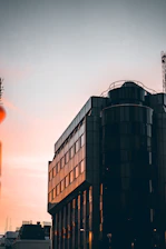 Ultra-realistic image of a sleek modern luxury residential development at sunset.