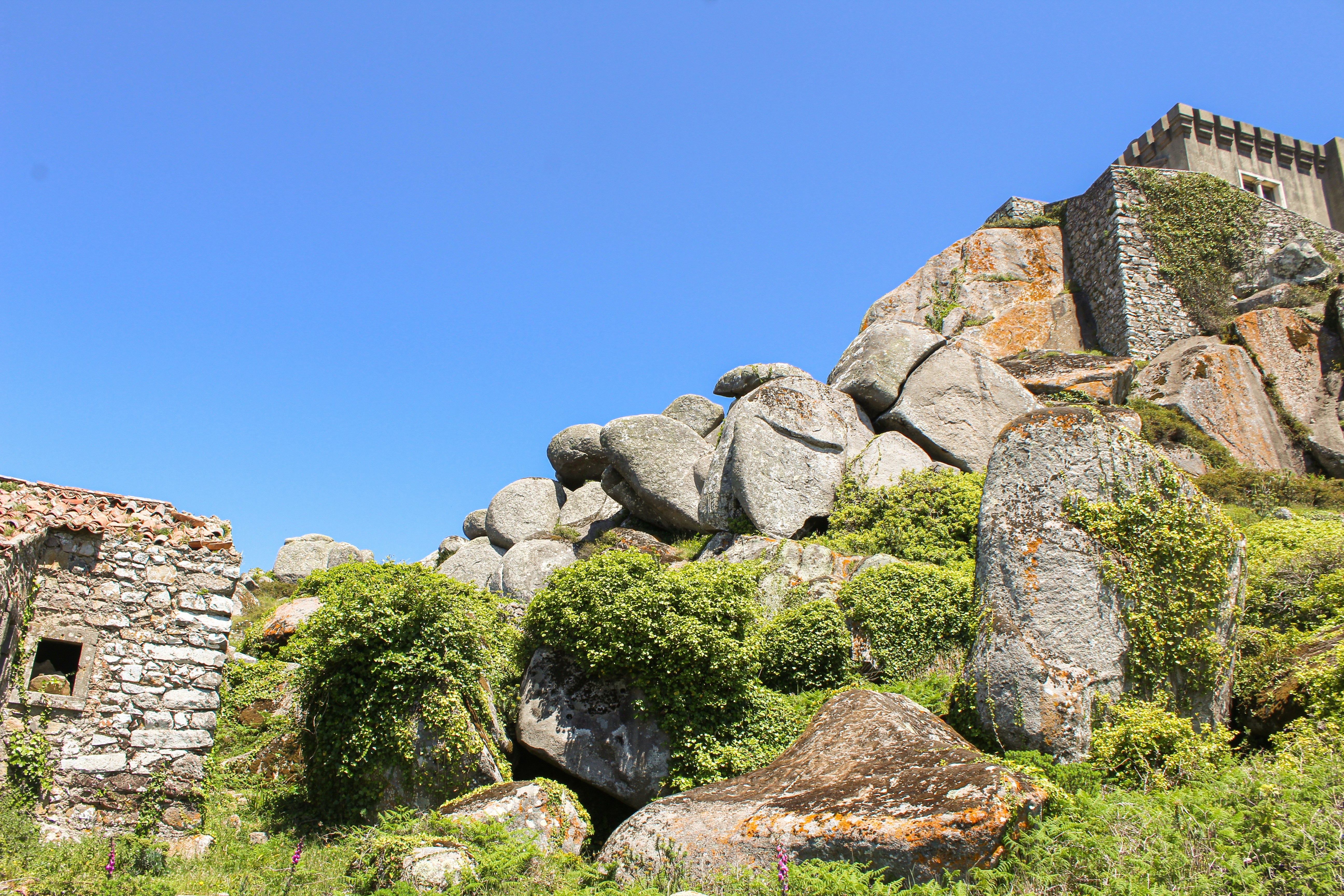 a stone building on a hill
