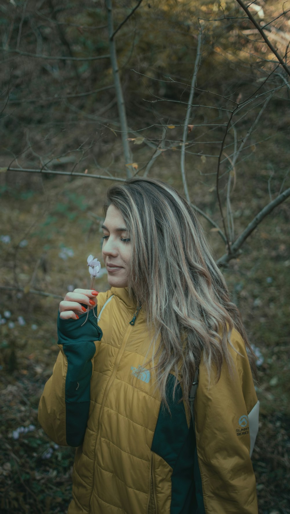 a woman holding a flower