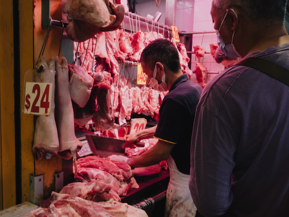 a group of men working at a butcher's shop