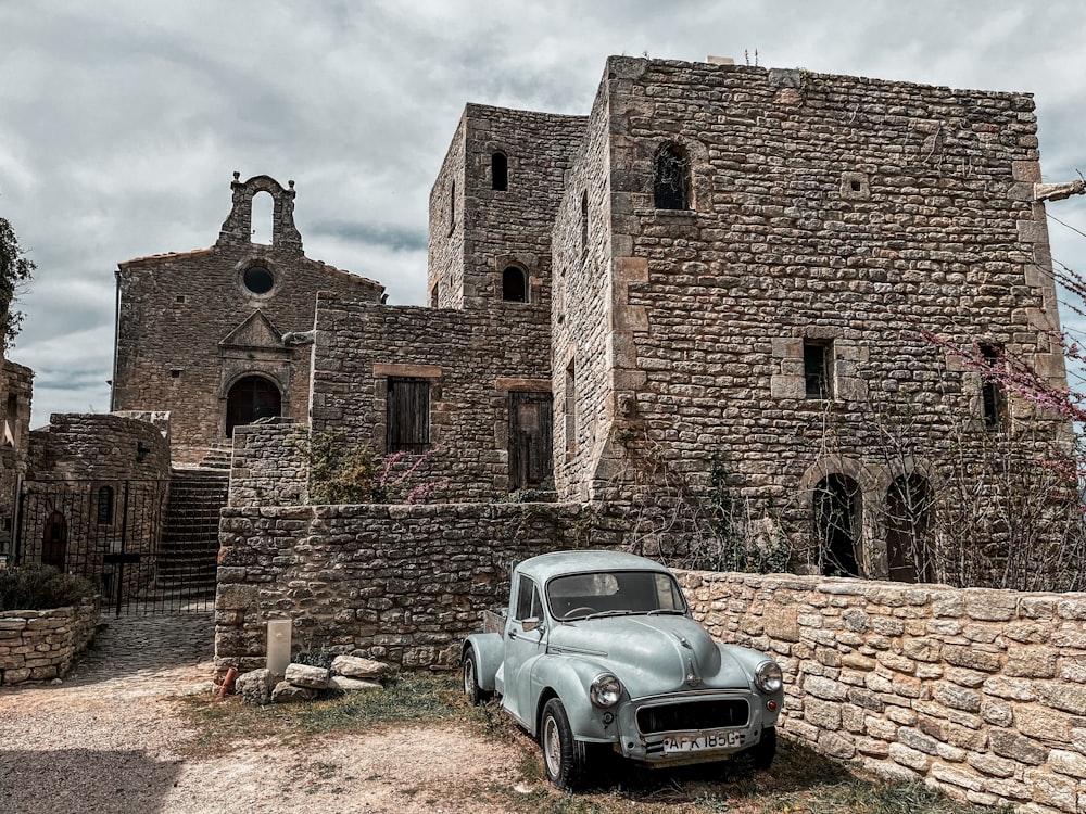 a car parked in front of a brick building