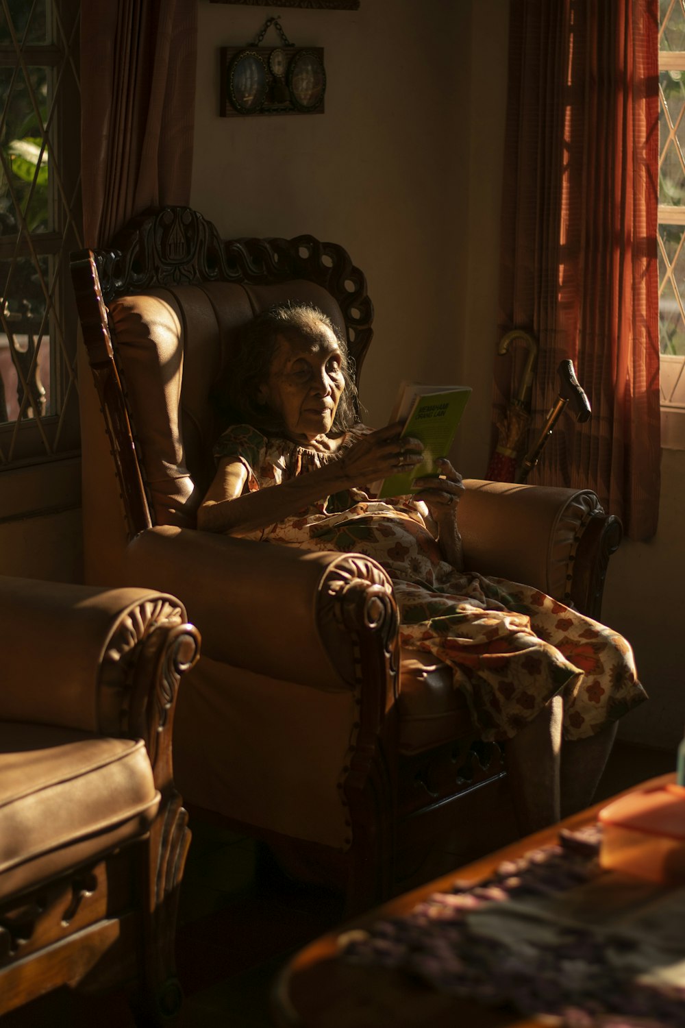 a person sitting in a chair reading a book