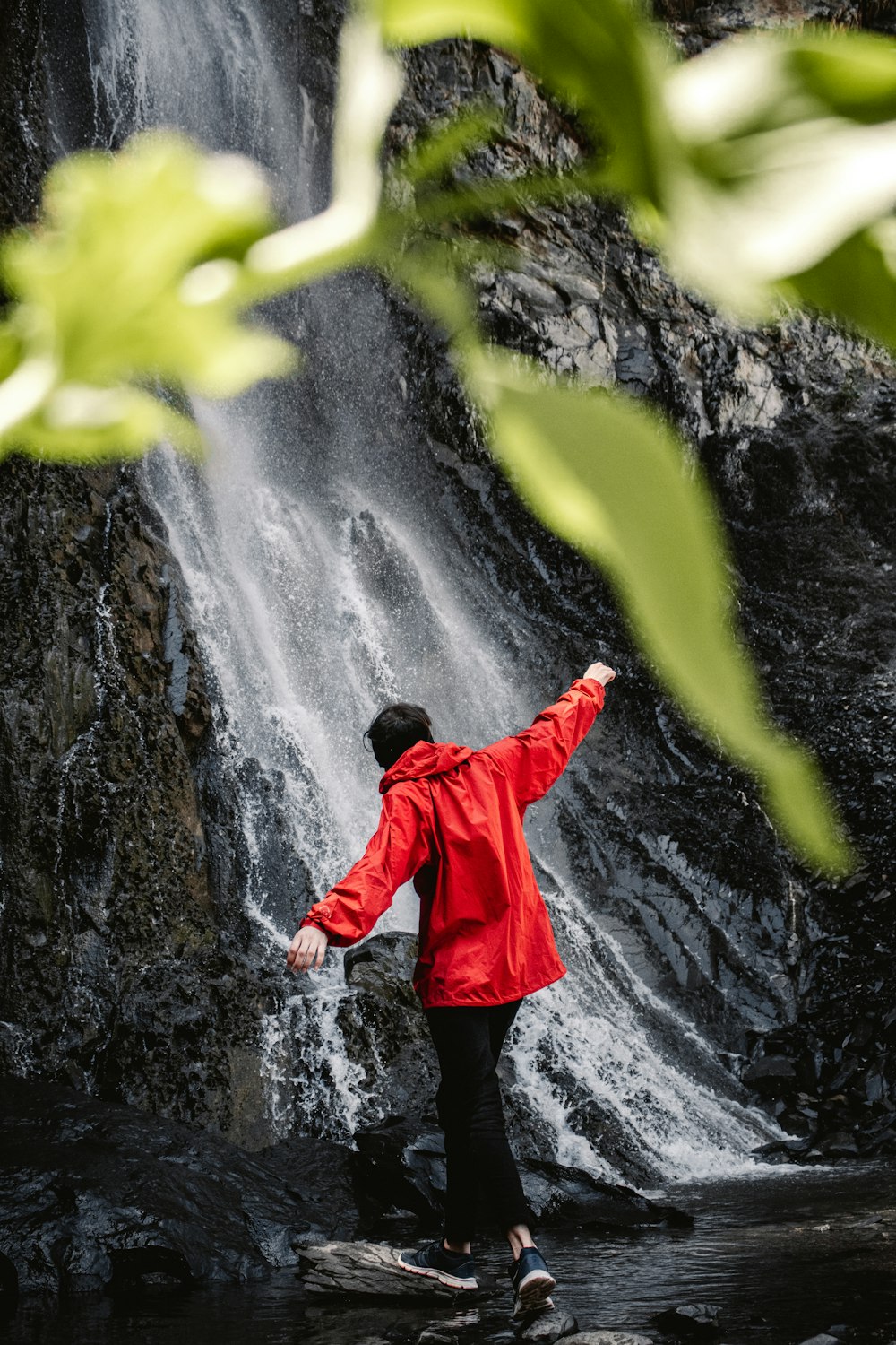 a person standing in front of a waterfall