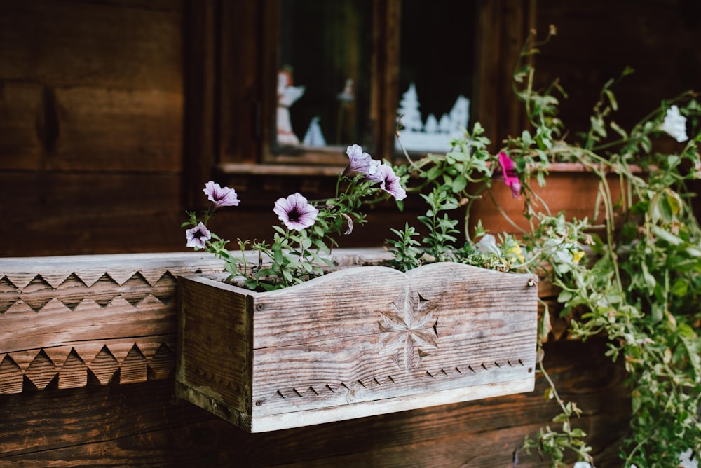 a wooden box with flowers in it