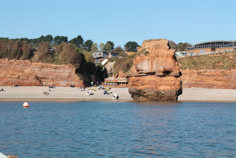 a body of water with a rock formation in the middle