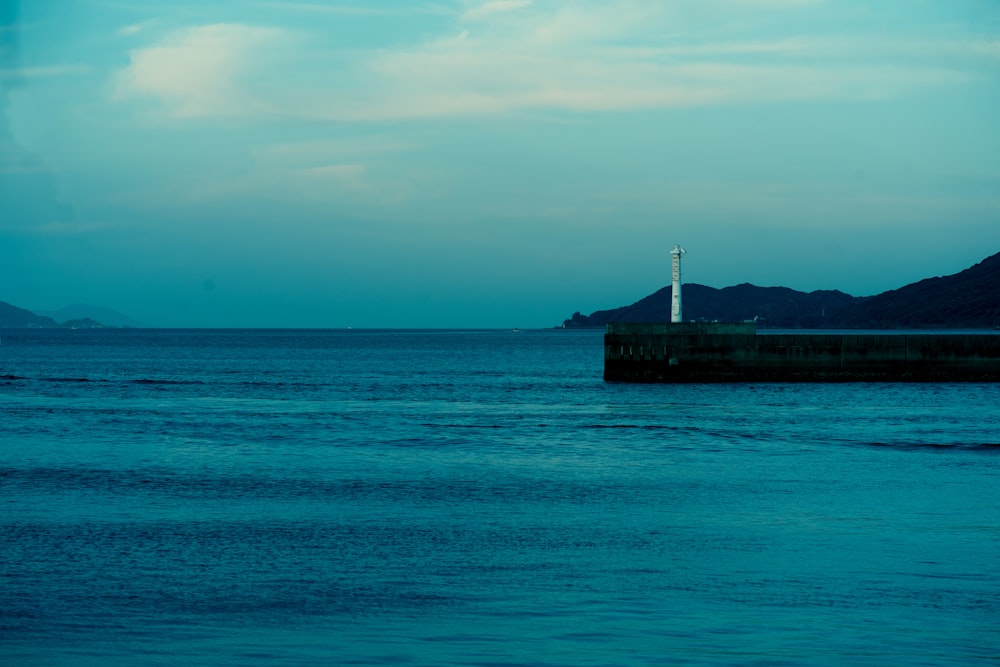 a body of water with a structure in the distance