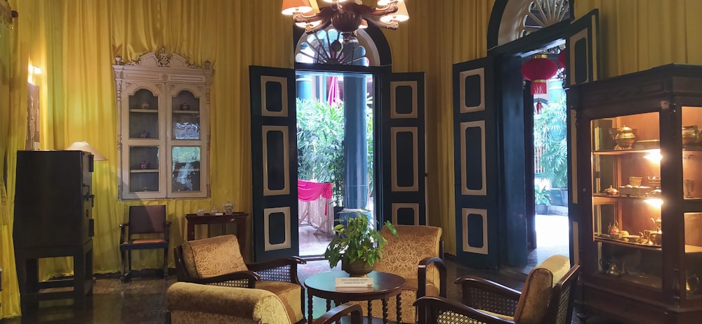 a room with a table chairs and a window with a view of a patio