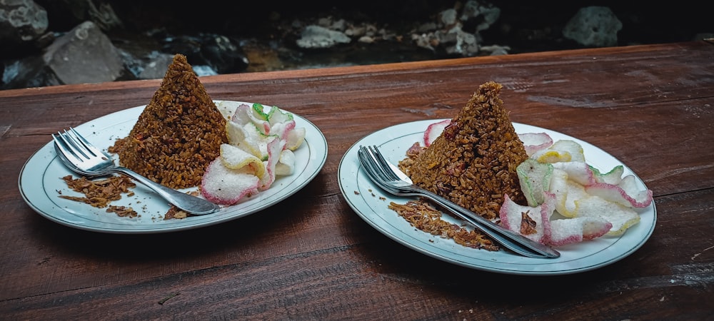 a couple of plates with food on them