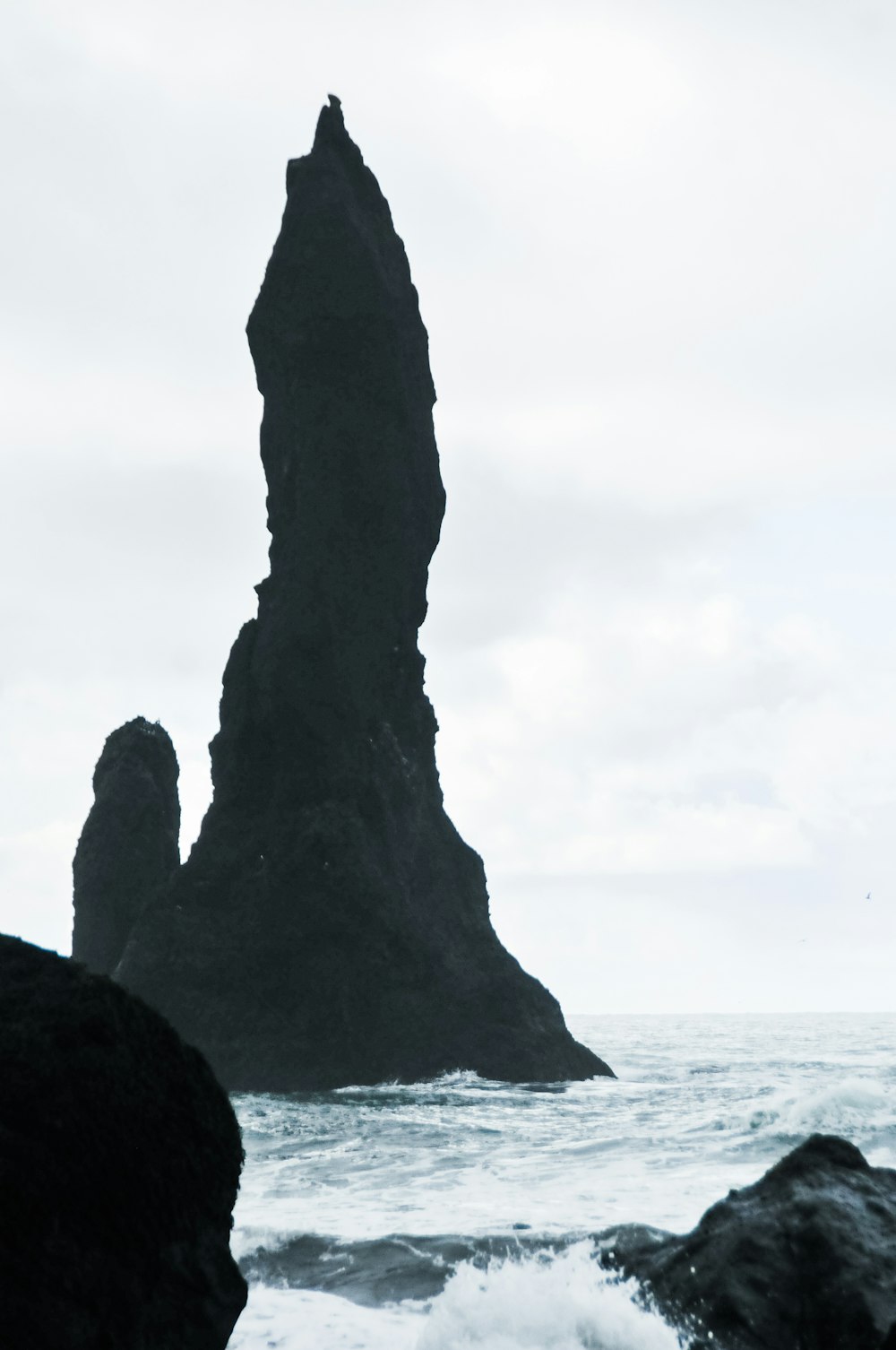 a person standing in front of a large rock