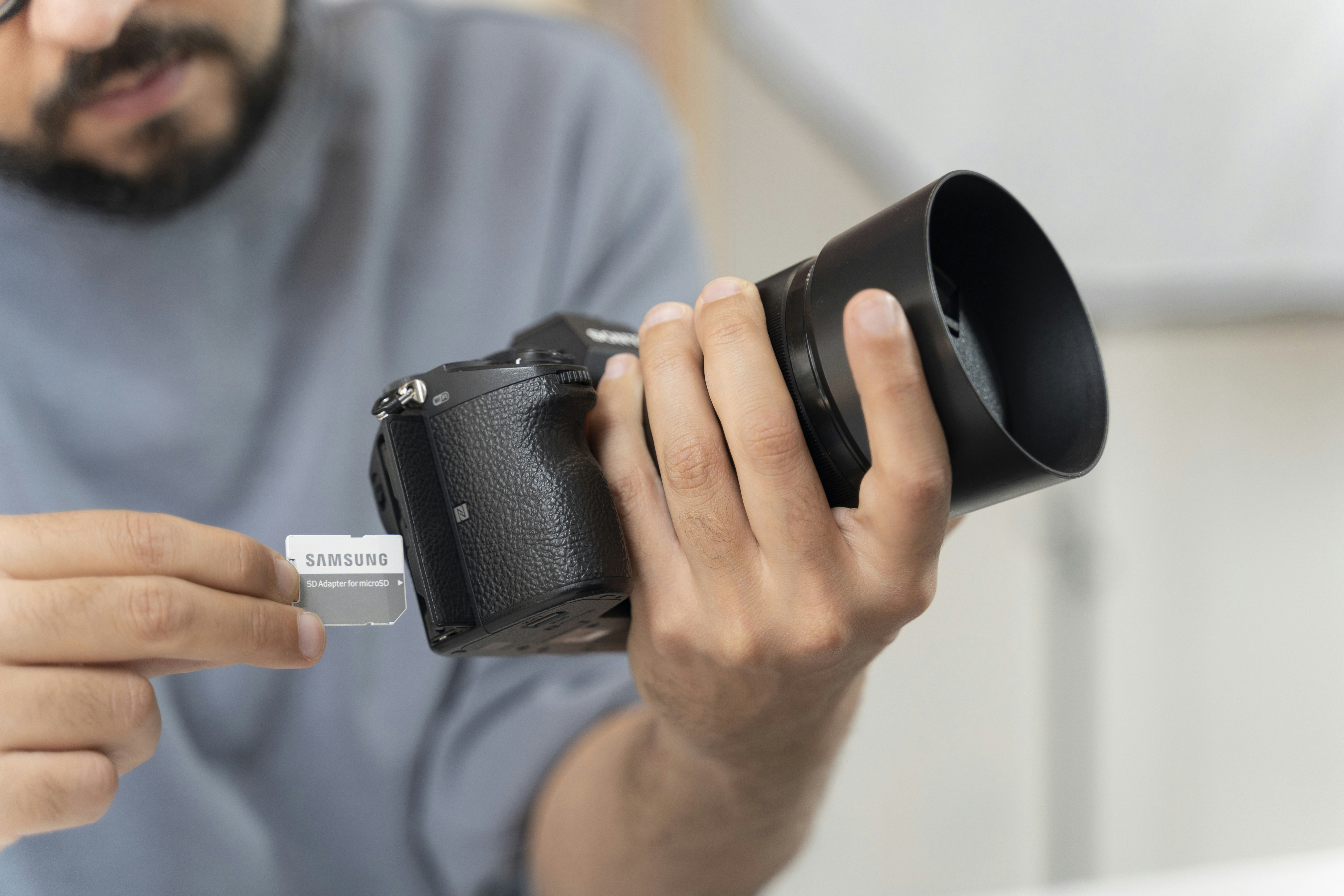 Photographer at work insert SD cart into camera