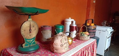 A collection of colorful vintage kitchen accessories and collectible decor on a retro countertop.