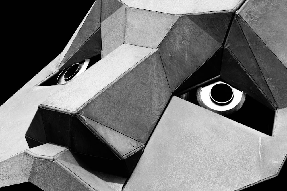 a black and white photo of a cube with a hole in it
