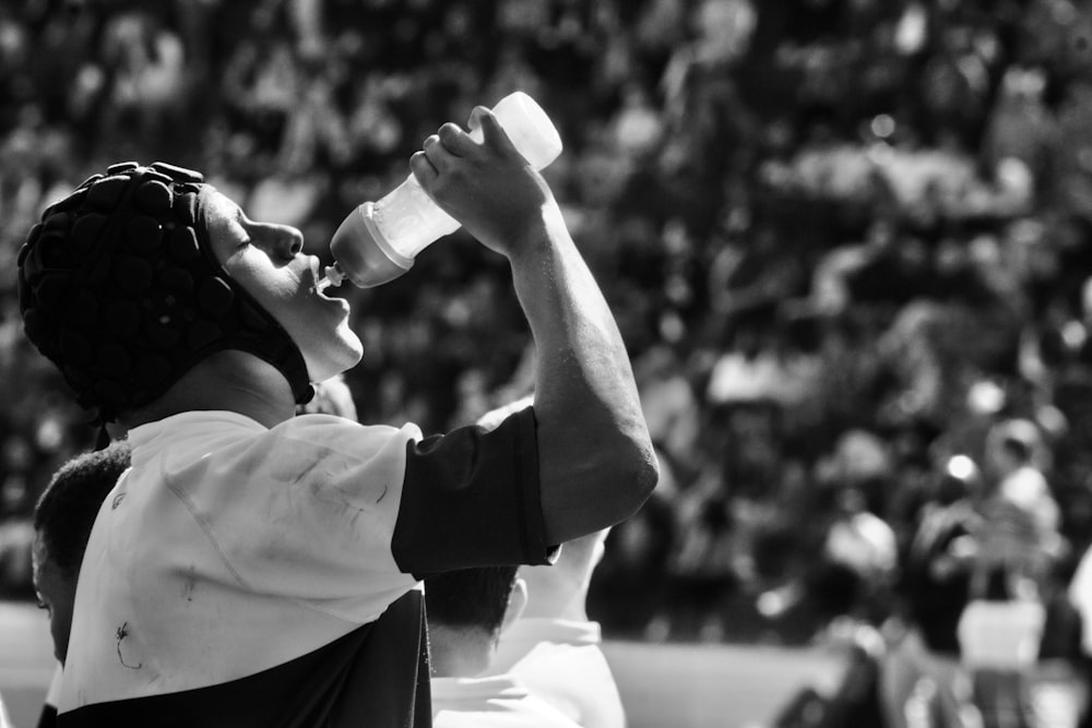 a person drinking from a bottle