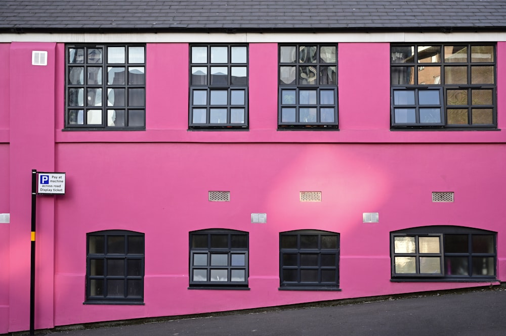 a pink building with windows